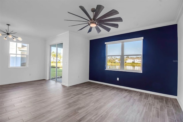 unfurnished room featuring light hardwood / wood-style floors, ceiling fan, and ornamental molding