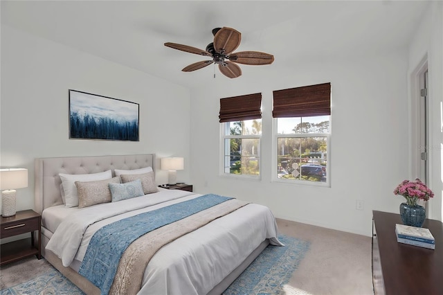 bedroom with ceiling fan and light carpet