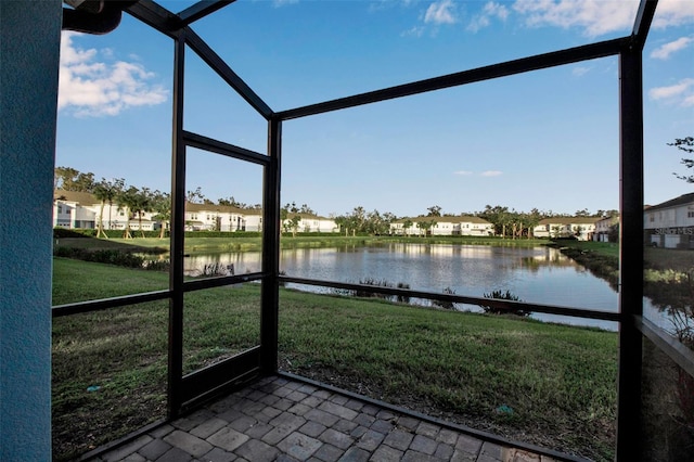 unfurnished sunroom with a water view