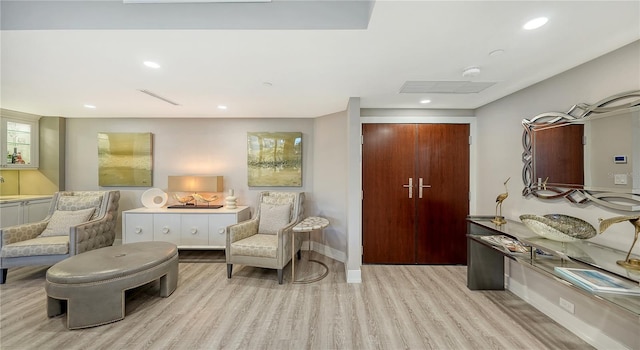 living area with light hardwood / wood-style floors