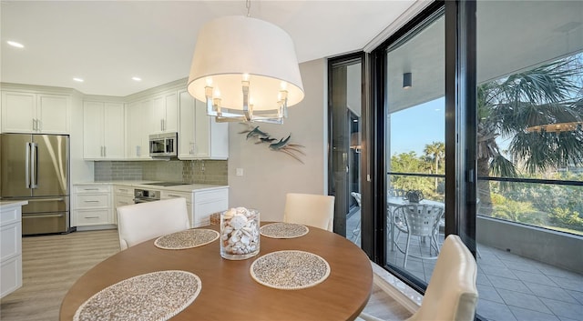 dining room featuring a notable chandelier and light wood-type flooring