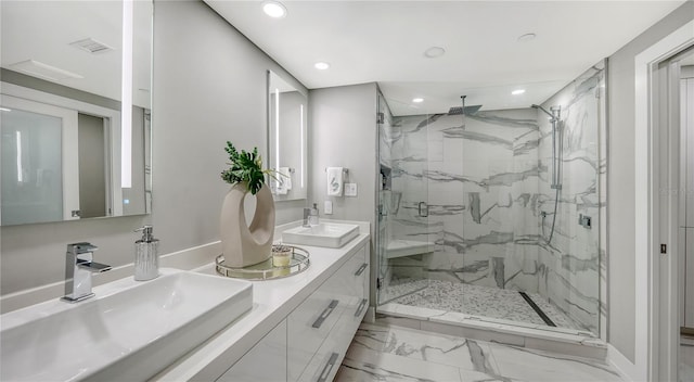 bathroom with vanity and a shower with door