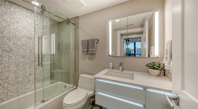 full bathroom with vanity, toilet, and enclosed tub / shower combo