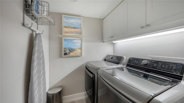 laundry area with cabinets and washing machine and dryer