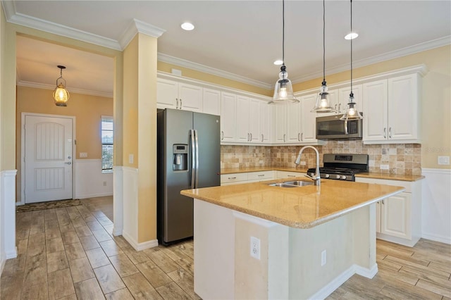 kitchen with white cabinetry, sink, a kitchen island with sink, appliances with stainless steel finishes, and light wood-type flooring