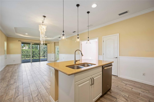 kitchen featuring stainless steel dishwasher, light hardwood / wood-style floors, sink, and an island with sink