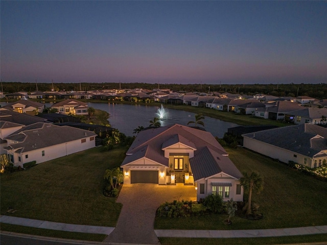 aerial view at dusk with a water view