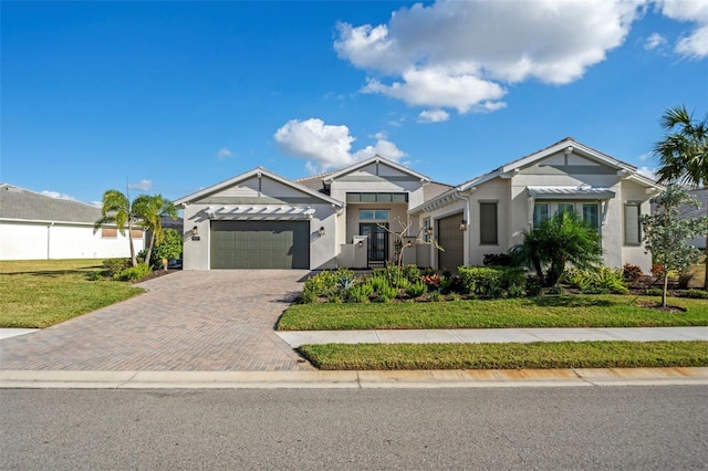 view of front of property featuring a front yard and a garage