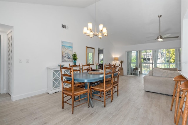 dining space featuring ceiling fan with notable chandelier, high vaulted ceiling, and light hardwood / wood-style flooring