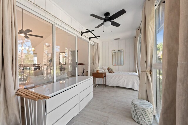 bedroom with light wood-type flooring and ceiling fan