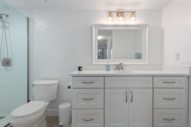 bathroom featuring vanity, toilet, wood-type flooring, and walk in shower