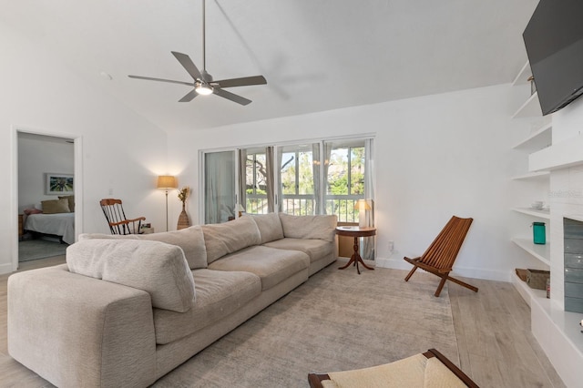 living room with ceiling fan, high vaulted ceiling, and light wood-type flooring