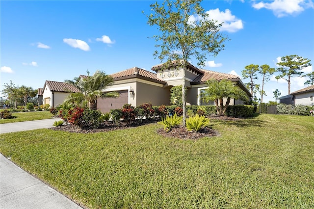 mediterranean / spanish home with a front lawn and a garage