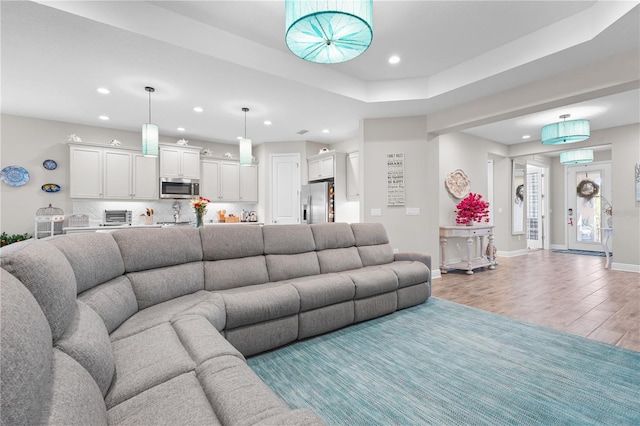 living room with light wood-type flooring and a wall mounted AC