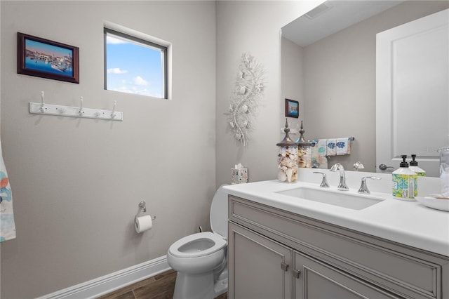 bathroom with hardwood / wood-style floors, vanity, and toilet