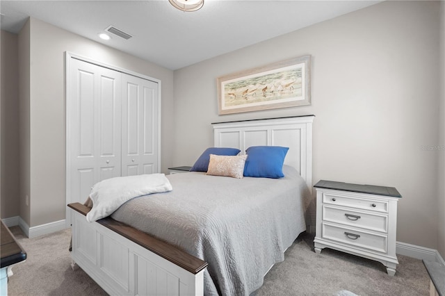 bedroom with a closet and light colored carpet