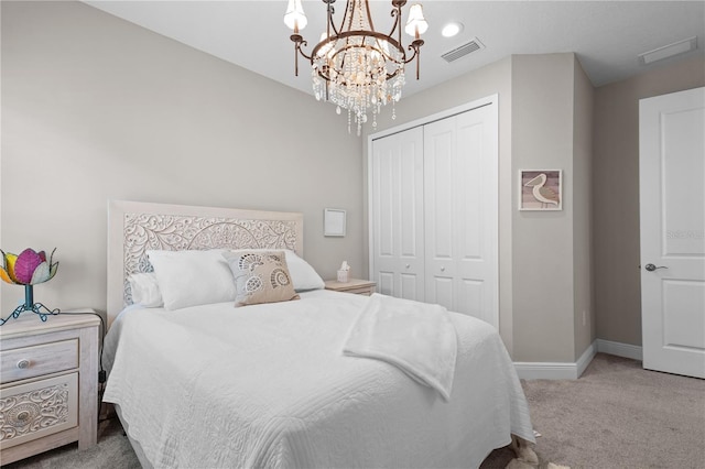 bedroom with light colored carpet, a closet, and a notable chandelier