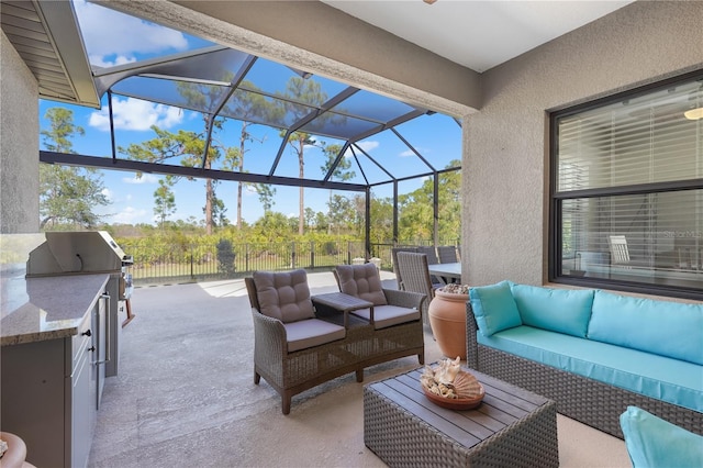 view of patio with outdoor lounge area and glass enclosure