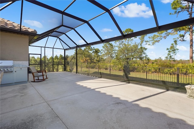 view of patio featuring area for grilling and a lanai