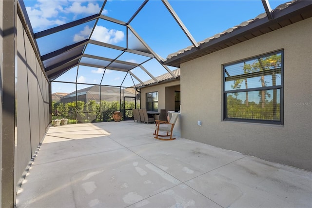 view of patio featuring a lanai