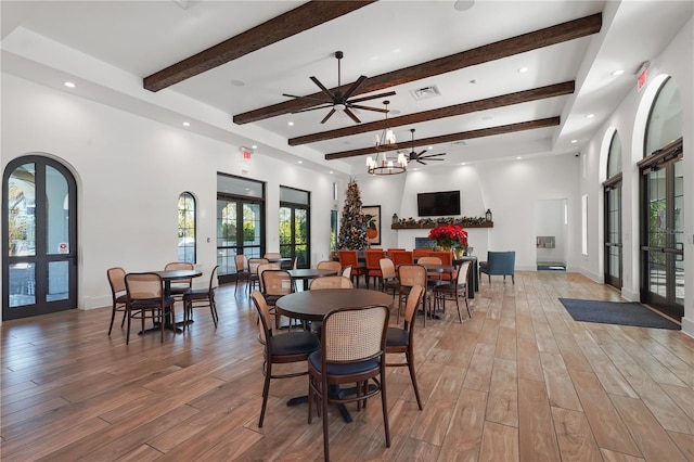 dining space featuring french doors, beamed ceiling, and hardwood / wood-style flooring