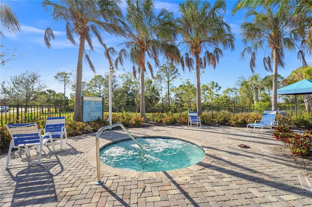 view of swimming pool with a patio area and a community hot tub