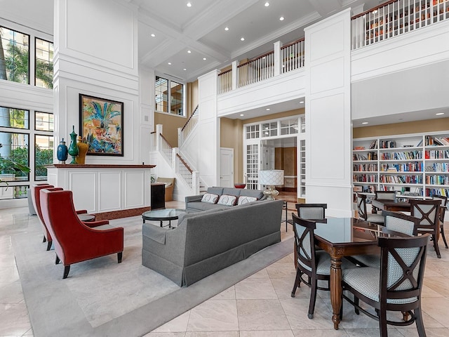 tiled living room with crown molding, coffered ceiling, beamed ceiling, and a high ceiling