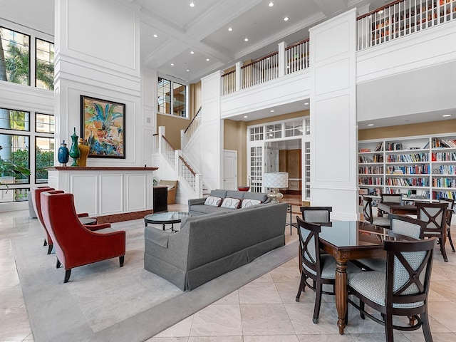 750 N Tamiami Trl Unit 420, Sarasota, FL 34236 - living room with a towering ceiling, ornamental molding, recessed lighting, beamed ceiling, and stairway