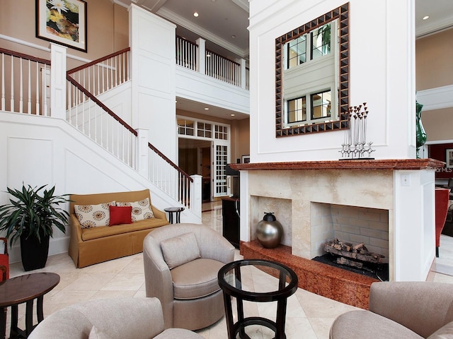 tiled living room featuring a premium fireplace, crown molding, and a high ceiling