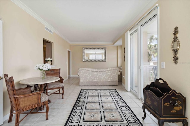 sitting room with light tile patterned floors, crown molding, and a wealth of natural light