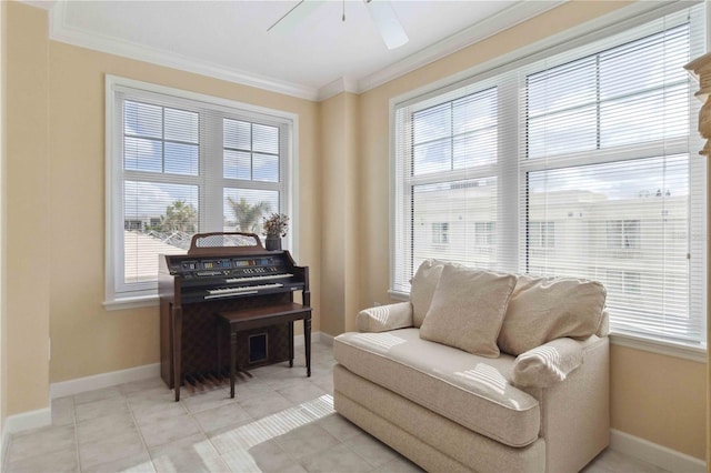 sitting room with ceiling fan, light tile patterned flooring, and ornamental molding