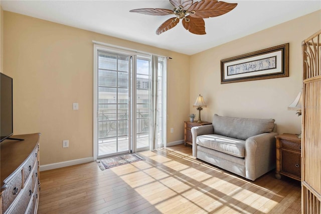 sitting room with ceiling fan and light hardwood / wood-style flooring