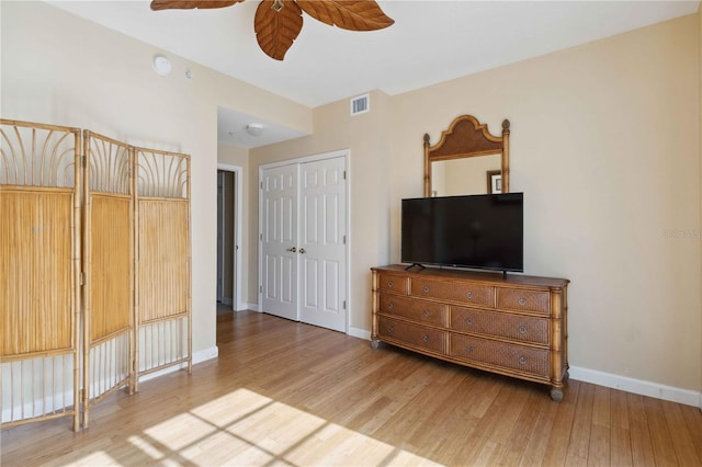 interior space with wood-type flooring, a closet, and ceiling fan