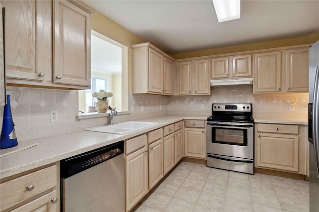 kitchen featuring light brown cabinets, stainless steel appliances, tasteful backsplash, and sink