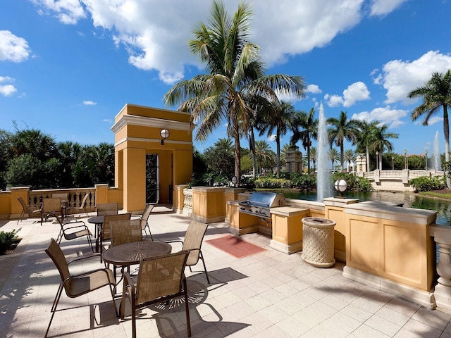 view of patio / terrace featuring area for grilling and a water view