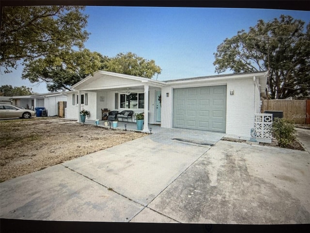 single story home featuring a porch and a garage