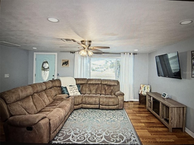 living room with ceiling fan and dark hardwood / wood-style flooring