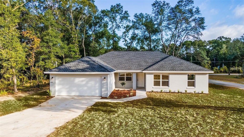 ranch-style home featuring a garage and a front lawn