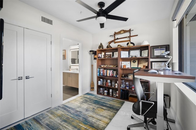 office space with ceiling fan and sink