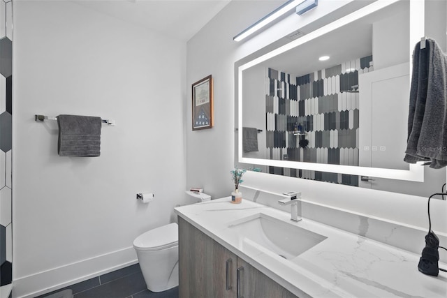 bathroom featuring tile patterned flooring, vanity, and toilet