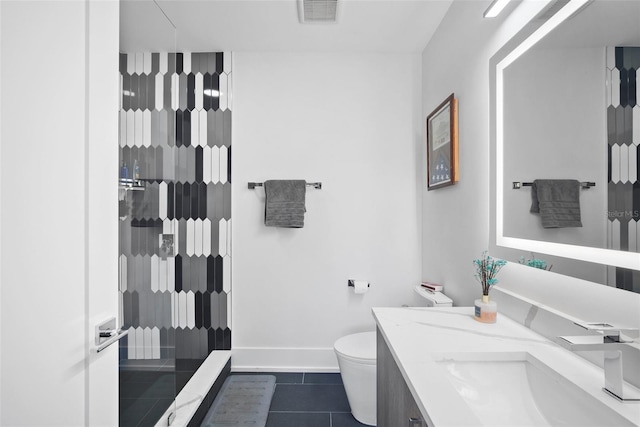 bathroom featuring tile patterned flooring, a shower, vanity, and toilet