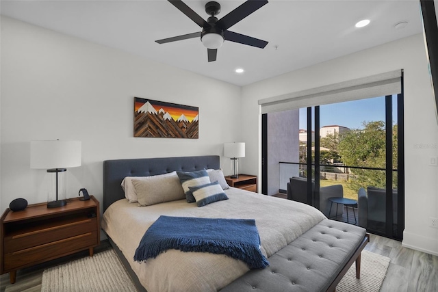 bedroom featuring access to outside, light hardwood / wood-style floors, and ceiling fan