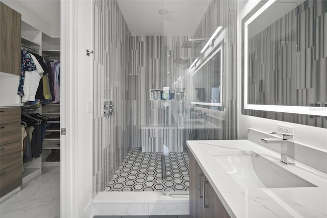 bathroom with vanity and a tile shower