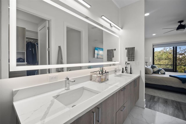 bathroom featuring ceiling fan and vanity