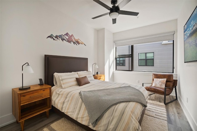 bedroom with ceiling fan and hardwood / wood-style floors