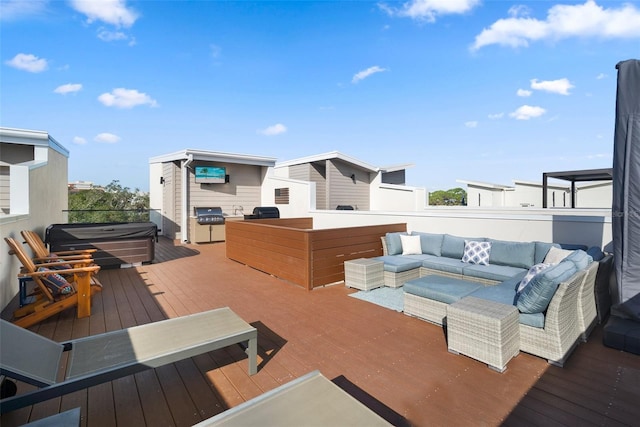 wooden deck featuring outdoor lounge area, a grill, and a hot tub