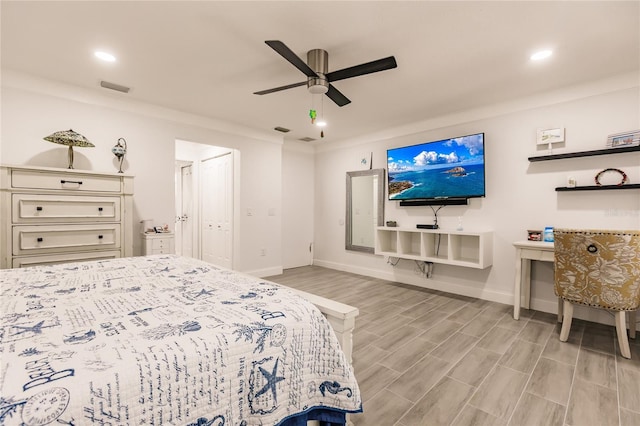 bedroom featuring ceiling fan, light hardwood / wood-style flooring, and ornamental molding