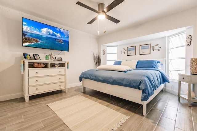 bedroom featuring wood-type flooring, ceiling fan, and ornamental molding