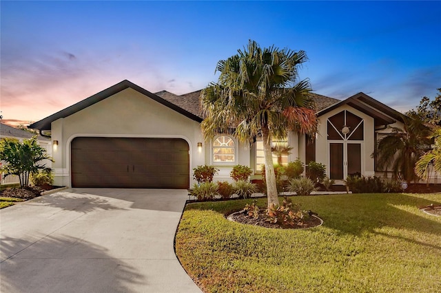 view of front of home featuring a garage and a lawn