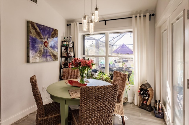 dining space featuring light hardwood / wood-style floors and a notable chandelier